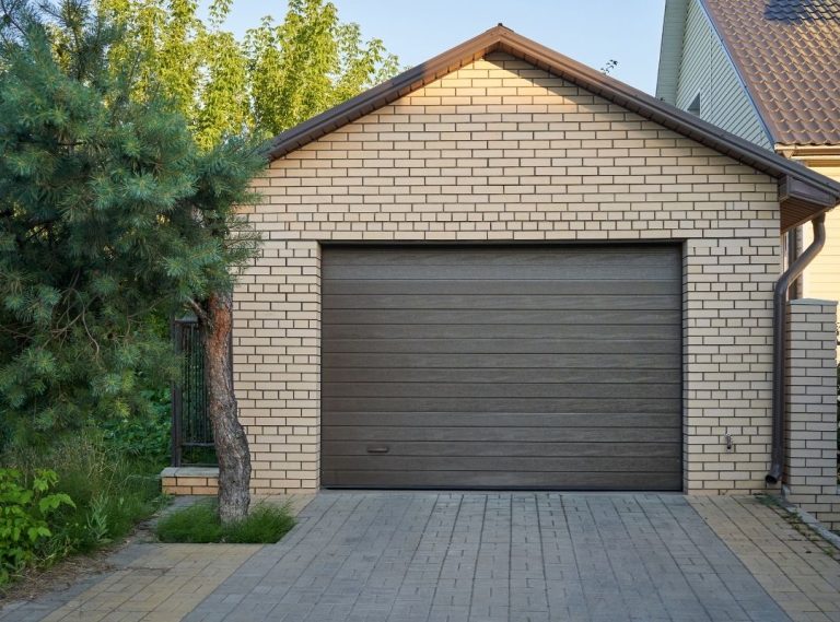 Brown sectional garage door installed on a brick home in Gretna.