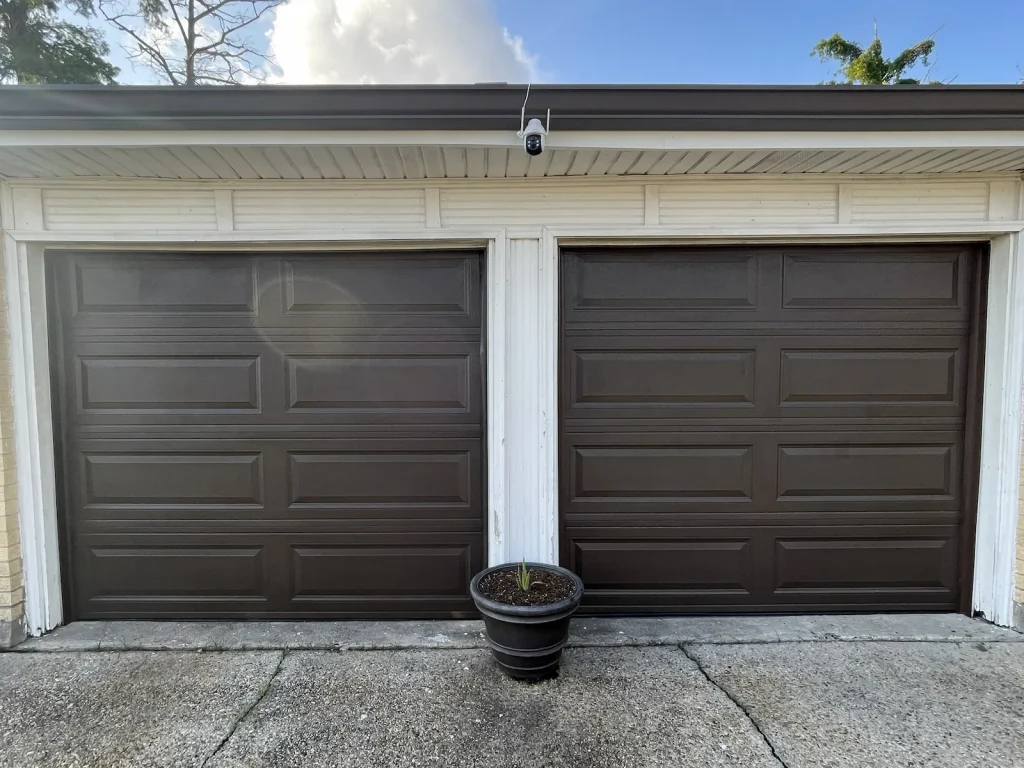 New brown carriage-style garage door installed on a New Orleans area home