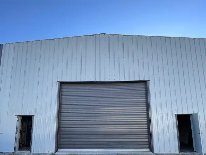 Rolling steel door at a busy warehouse loading dock