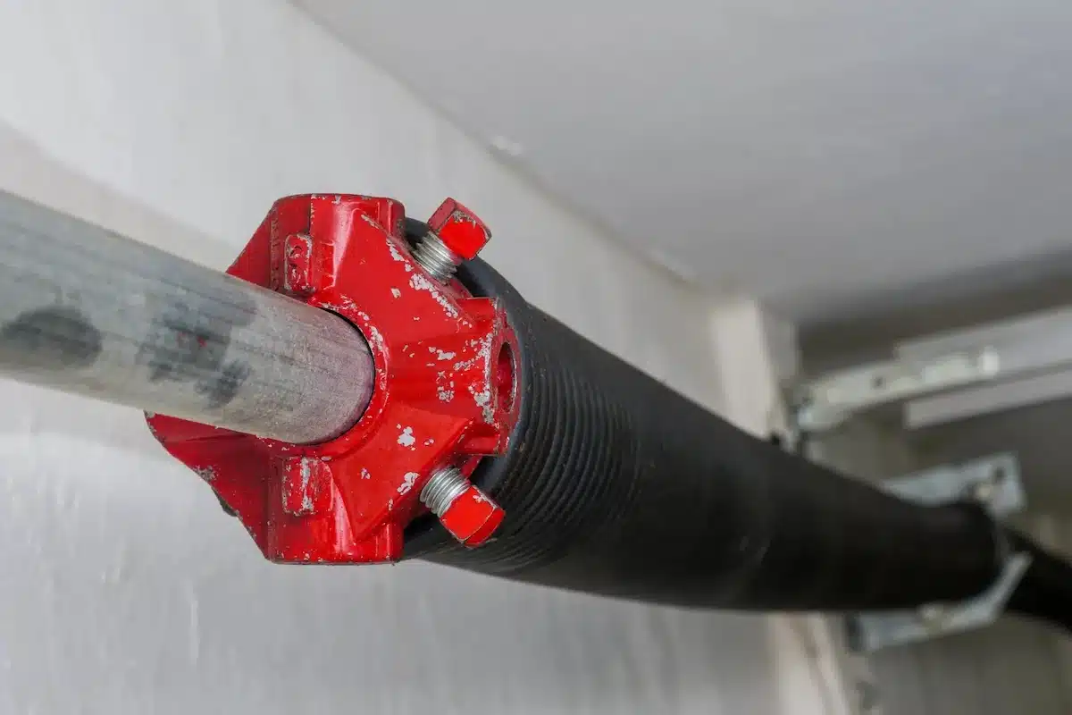 garage door torsion spring mounted above residential garage door